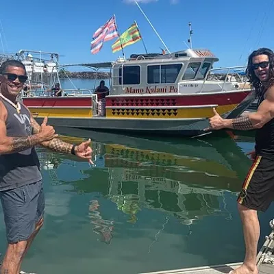 2 men in front of a boat