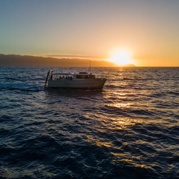 a boat on a body of water next to the ocean